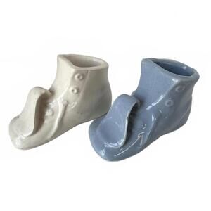 Vintage ceramic baby shoe planters, one white, one blue.